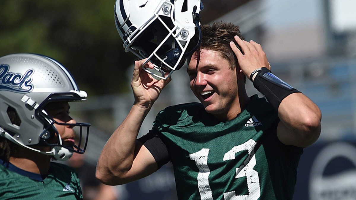 Nevada quarterback Chubba Purdy (13) laughs with his teammates during practice at Mackay Stadium in Reno on July 25, 2024.