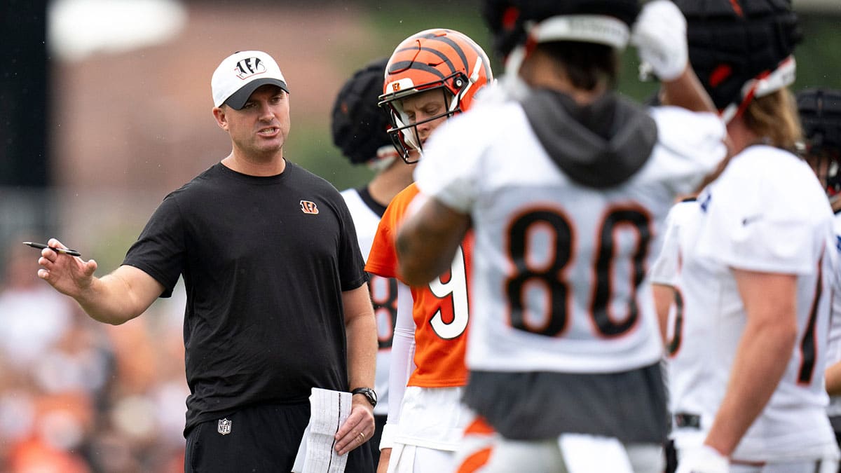 Cincinnati Bengals head coach Zac Taylor speaks with Cincinnati Bengals quarterback Joe Burrow (9) at Cincinnati Bengals training camp on the Kettering Health Practice Fields in Cincinnati on Sunday, July 28, 2024.