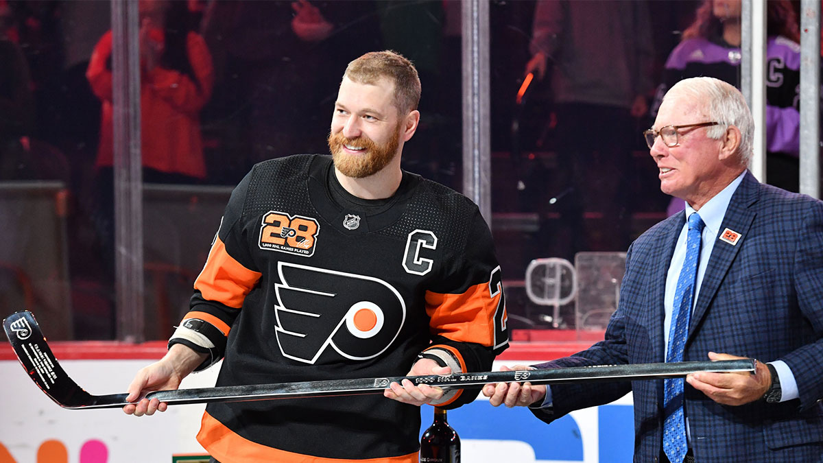 Philadelphia Flyers center Claude Giroux (28) receives a silver hockey stick from Bobby Clarke during a pregame ceremony honoring Giroux for his 1000th game as a Flyer before game against the Nashville Predators at Wells Fargo Center. 