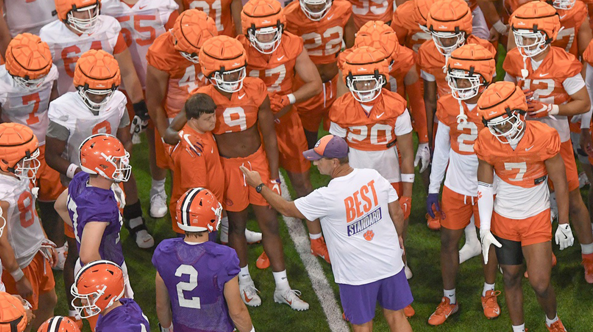 Clemson head coach Dabo Swinney talks with players during August practice