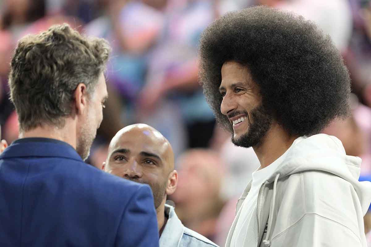 Former NFL player Colin Kaepernick and former NBA player Pau Gasol talk during the first half between the United States and Serbia in a men's basketball semifinal game during the Paris 2024 Olympic Summer Games at Accor Arena.