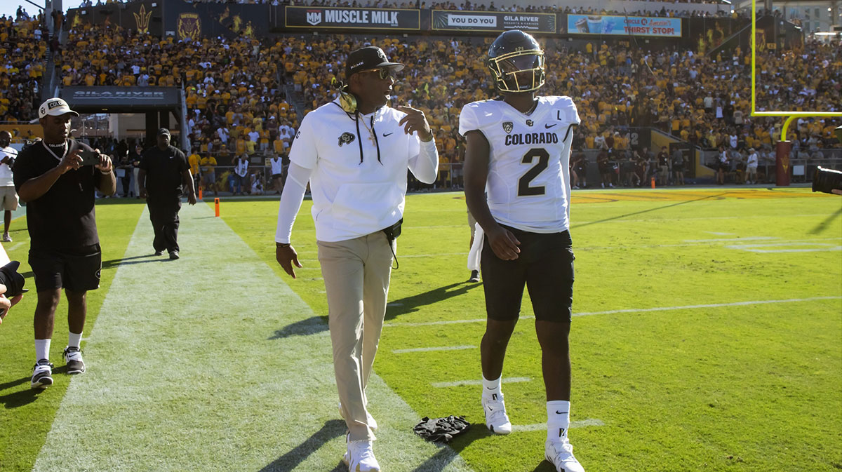 Colorado Buffaloes head coach Deion Sanders with son and quarterback Shedeur Sanders (2) against the Arizona State Sun Devils at Mountain America Stadium.