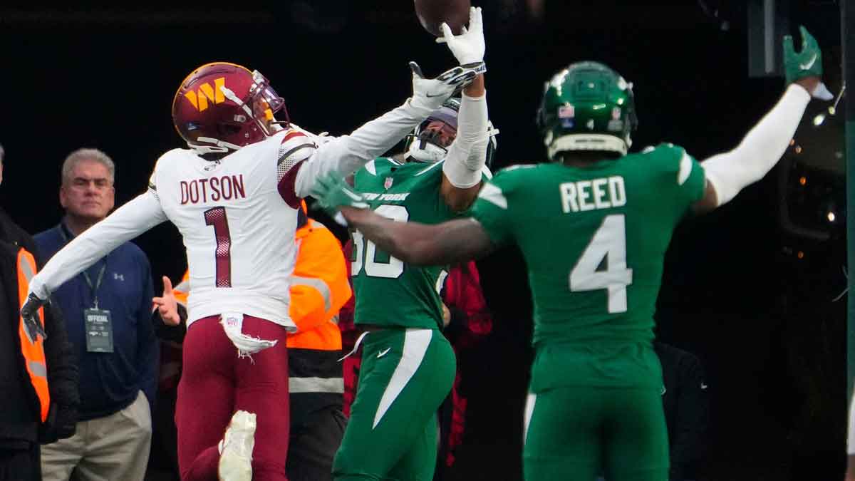 New York Jets cornerback Michael Carter II (30) breaks up a pass intended for Washington Commanders wide receiver Jahan Dotson (1) in the second half at MetLife Stadium.