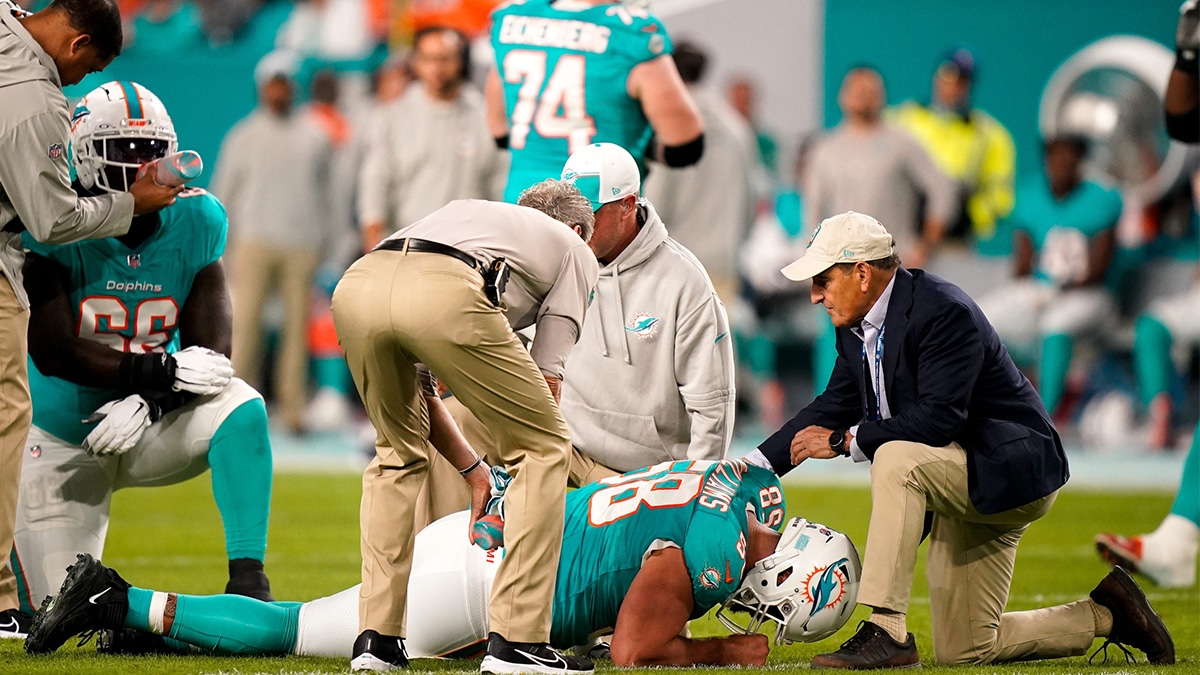 Miami Dolphins guard Connor Williams (58) is check out by staff during the first quarter against the Tennessee Titans at Hard Rock Stadium in Miami, Fla., Monday, Dec. 11, 2023