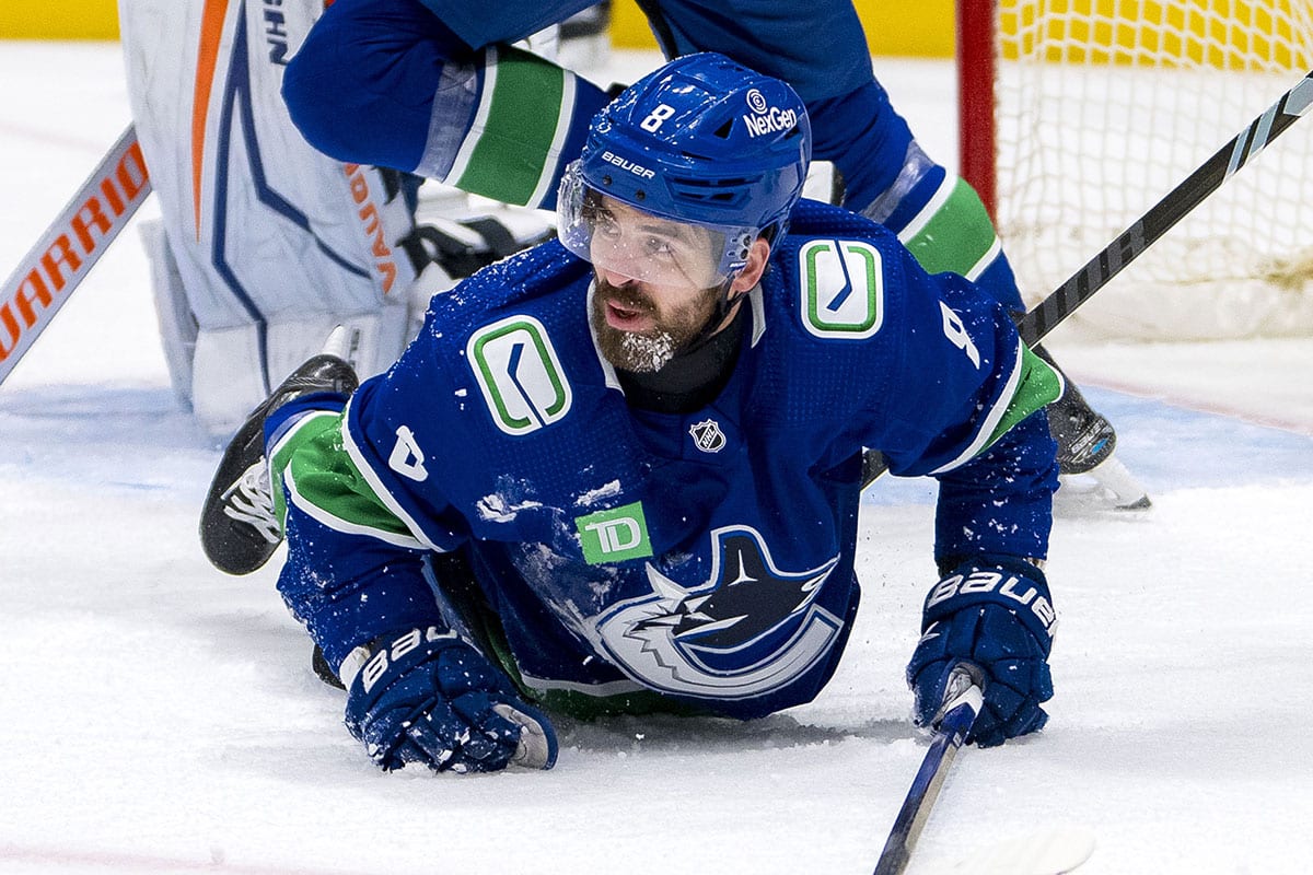  Vancouver Canucks forward Conor Garland (8) gets up off the ice after being checked against the Edmonton Oilers during the third period in game five of the second round of the 2024 Stanley Cup Playoffs at Rogers Arena.