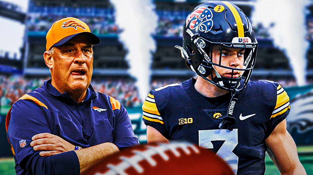 Cooper DeJean next to Vic Fangio with Lincoln Financial Field as the background.