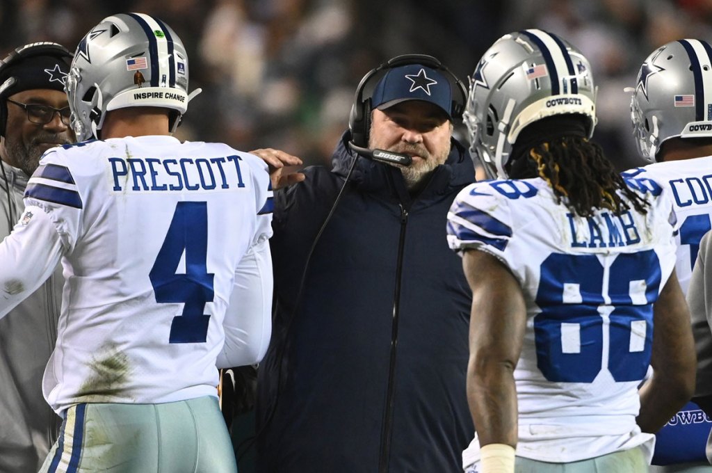 Dallas Cowboys head coach Mike McCarthy (M) celebrates with Cowboys quarterback Dak Prescott (4) and Cowboys wide receiver CeeDee Lamb (88) on the sidelines after a touchdown against the Philadelphia Eagles during the second quarter at Lincoln Financial Field.