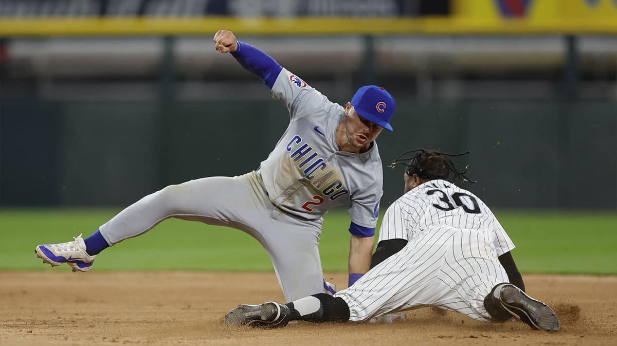 Aug 9, 2024; Chicago, Illinois, USA; Chicago Cubs second baseman Nico Hoerner (2) tags out Chicago White Sox outfielder Corey Julks (30) at second base during the eighth inning at Guaranteed Rate Field