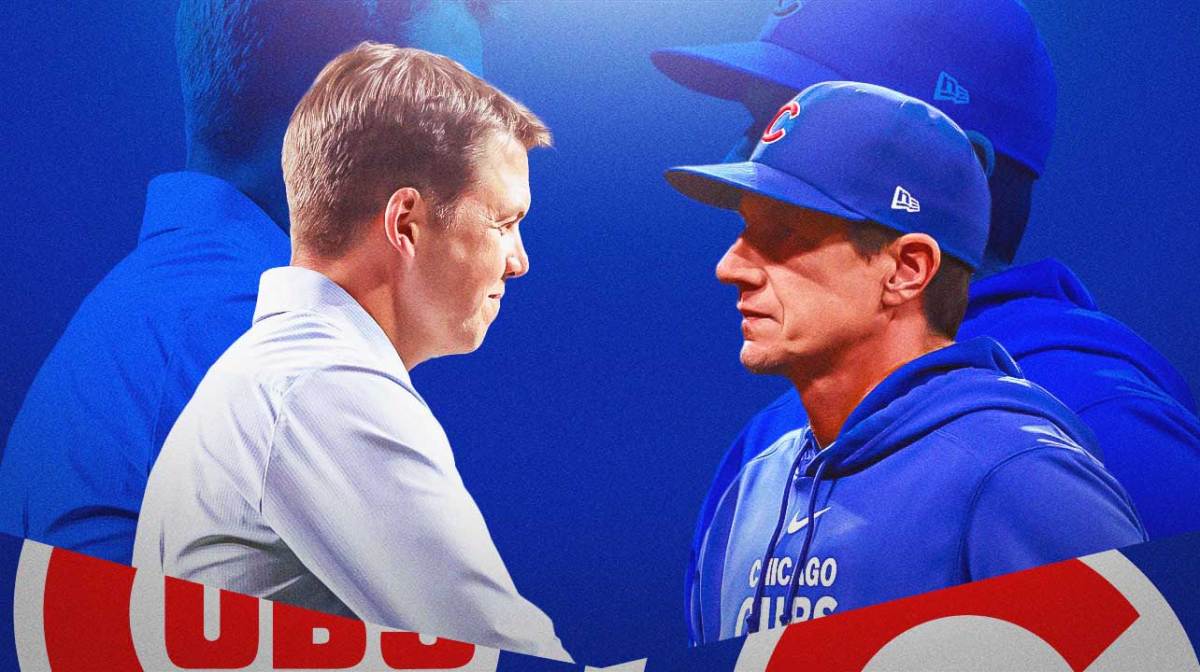 Cubs GM Carter Hawkins looks at manager Craig Counsell in Cubs gear
