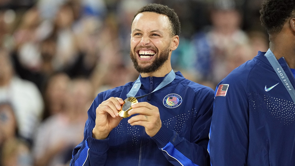  United States shooting guard Stephen Curry (4) celebrates with the gold medal after the game against France in the men's basketball gold medal game during the Paris 2024 Olympic Summer Games at Accor Arena.