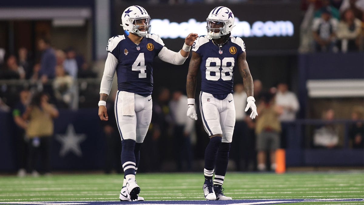 Dallas Cowboys wide receiver CeeDee Lamb (88) and quarterback Dak Prescott (4) talk during the game against the Washington Commanders at AT&T Stadium.