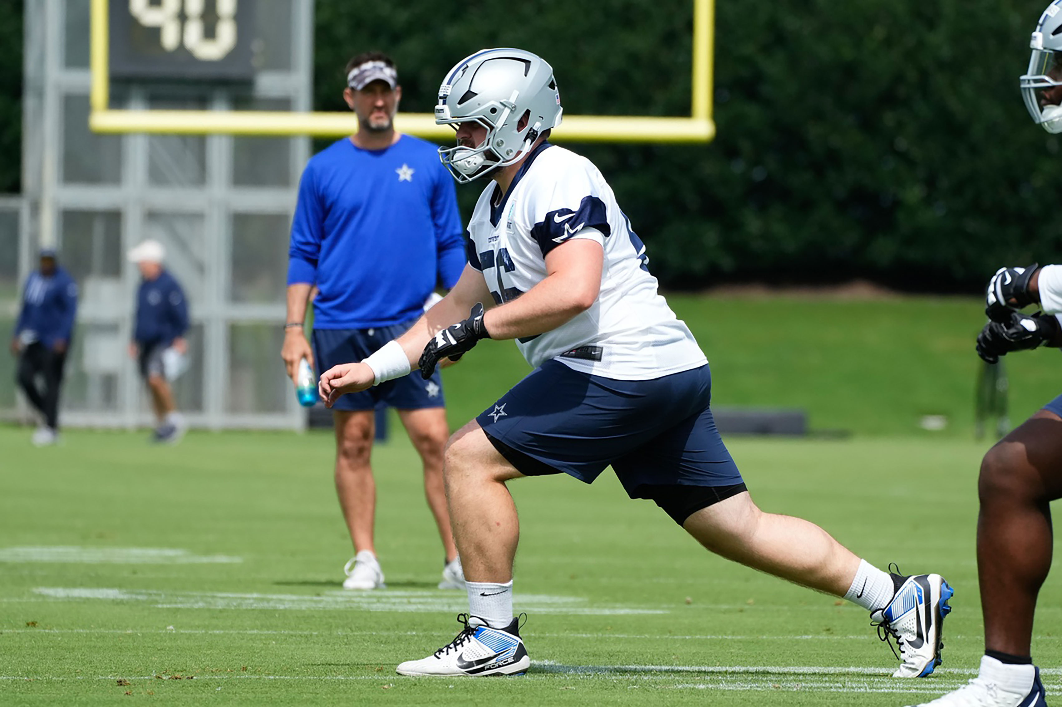 Dallas Cowboys center Cooper Beebe (56) goes through a drill during practice at the Ford Center at the Star Training Facility in Frisco, Texas. 