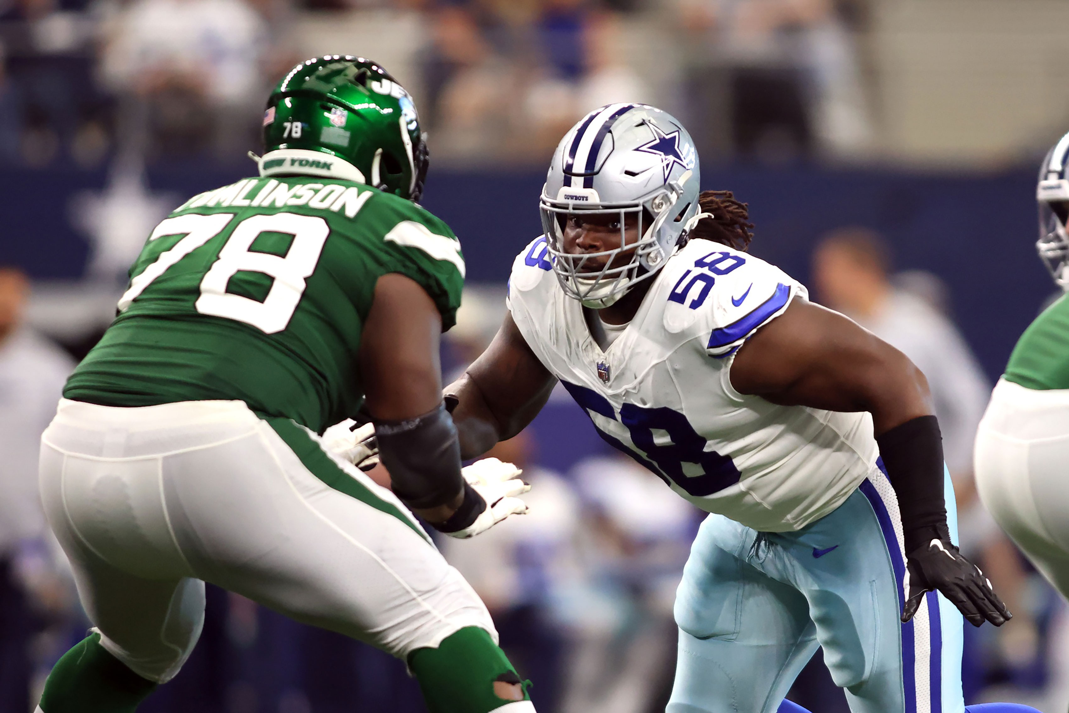 Dallas Cowboys defensive tackle Mazi Smith (58) rushes the passer while blocked by New York Jets guard Laken Tomlinson (78) in the third quarter at AT&T Stadium. 