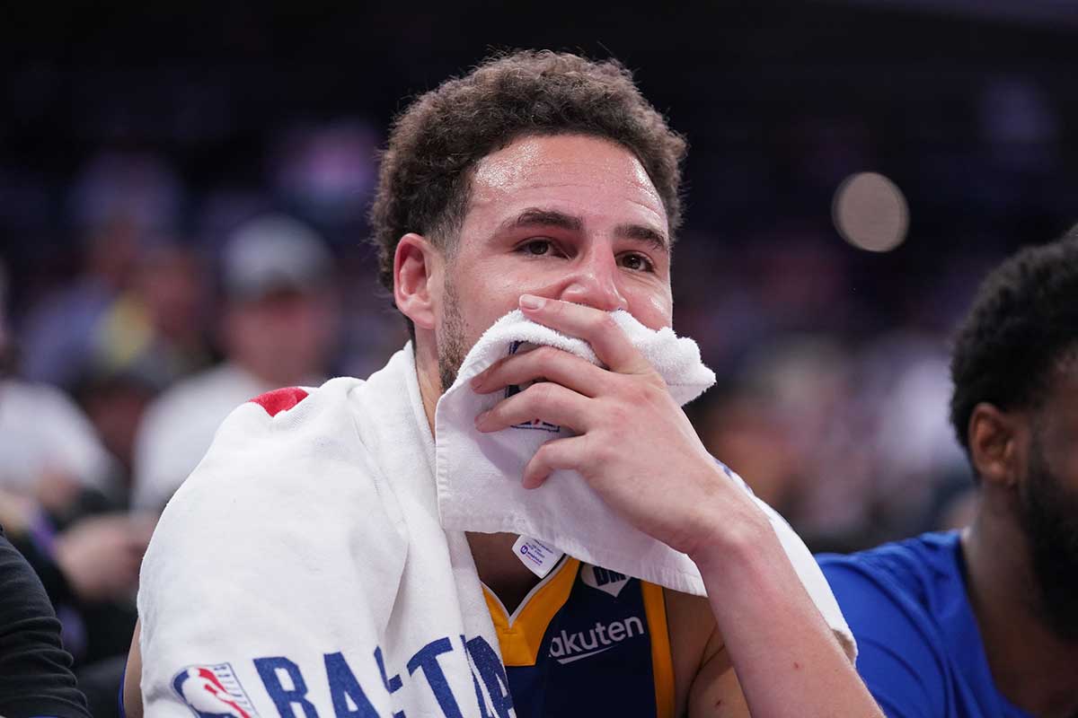 Golden State Warriors guard Klay Thompson (11) sits on the bench during action against the Sacramento Kings in the fourth quarter during a play-in game of the 2024 NBA playoffs at the Golden 1 Center. 