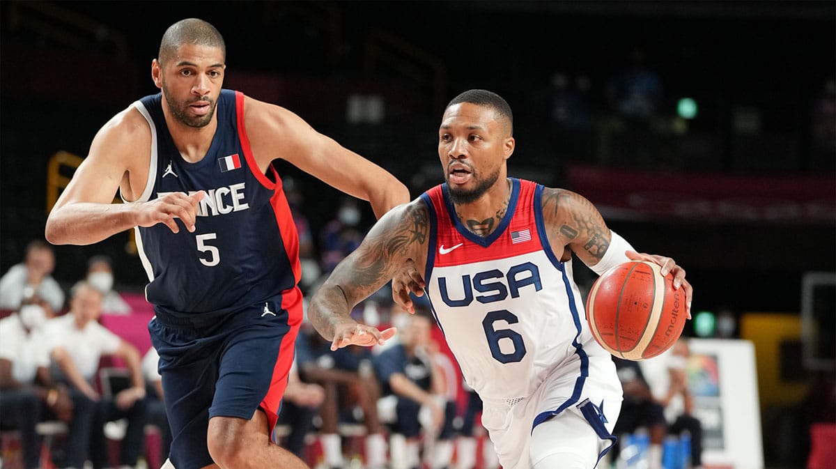 USA player Damian Lillard (6) drives against France player Nicolas Batum (5) during the Tokyo 2020 Olympic Summer Games at Saitama Super Arena.