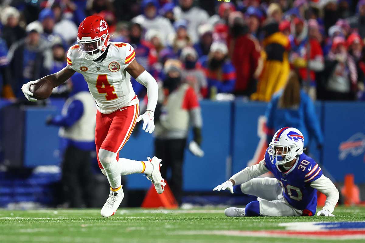 Jan 21, 2024; Orchard Park, New York, USA; Kansas City Chiefs wide receiver Rashee Rice (4) runs with the ball after a catch against Buffalo Bills cornerback Dane Jackson (30) during the second half for the 2024 AFC divisional round game at Highmark Stadium.
