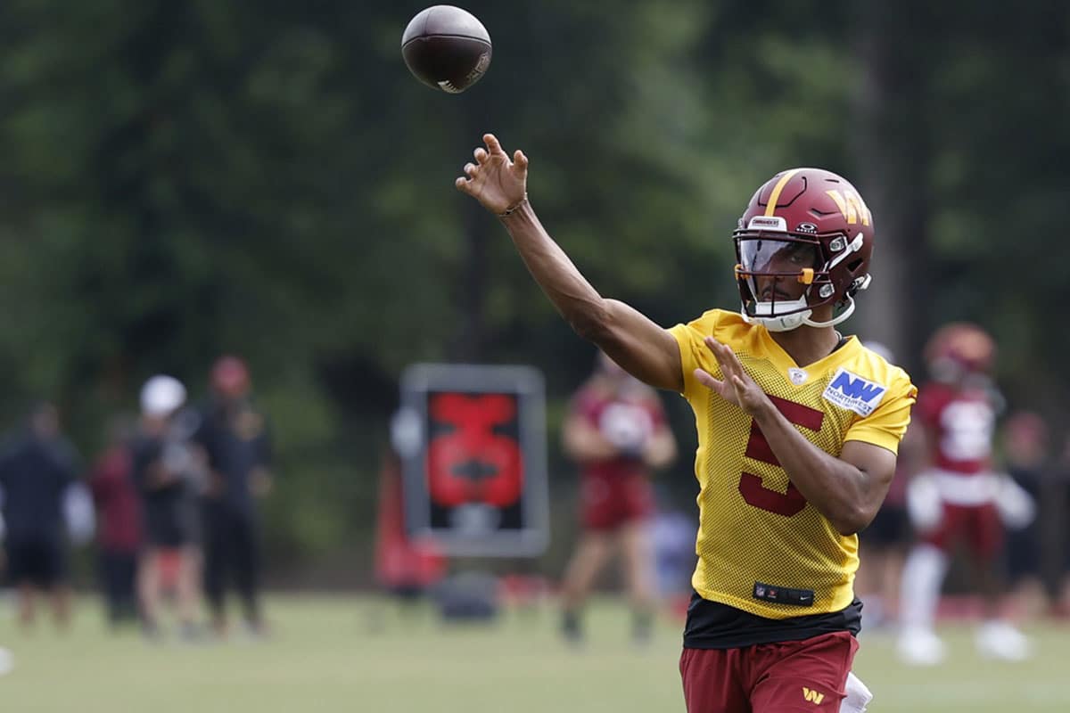 Washington Commanders quarterback Jayden Daniels (5) passes the ball on day three of training camp at Commanders Park.