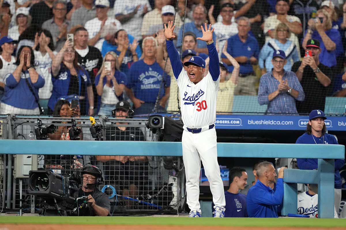 Los Angeles Dodgers manager Dave Roberts (30) celebrates after a three-run home run by Los Angeles Dodgers right fielder Jason Heyward (not pictured) in the eighth inning against the Seattle Mariners at Dodger Stadium.