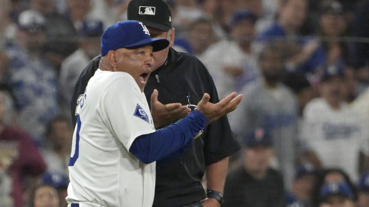 Los Angeles Dodgers manager Dave Roberts (30) is ejected by umpire Hunter Wendelstedt (21) after arguing an interference call by Los Angeles Dodgers shortstop Miguel Rojas (11) in the sixth inning against the Philadelphia Phillies at Dodger Stadium.