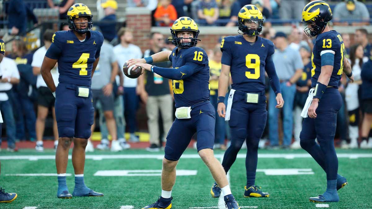 Michigan Wolverines quarterback Davis Warren (16) warms up before action against the Bowling Green Falcons