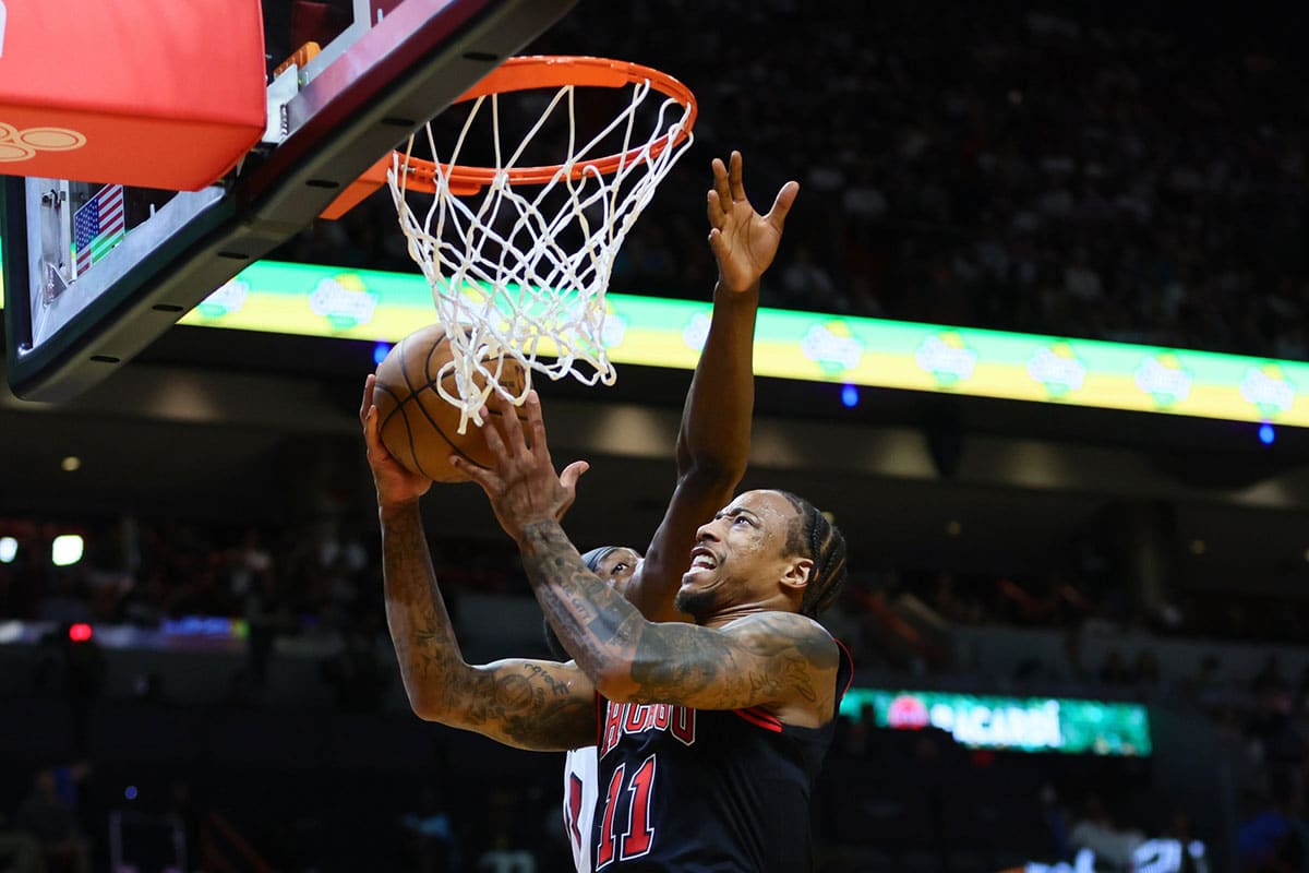 Chicago Bulls forward DeMar DeRozan (11) drives to the basket against Miami Heat center Bam Adebayo (13) in the second quarter during a play-in game of the 2024 NBA playoffs at Kaseya Center.