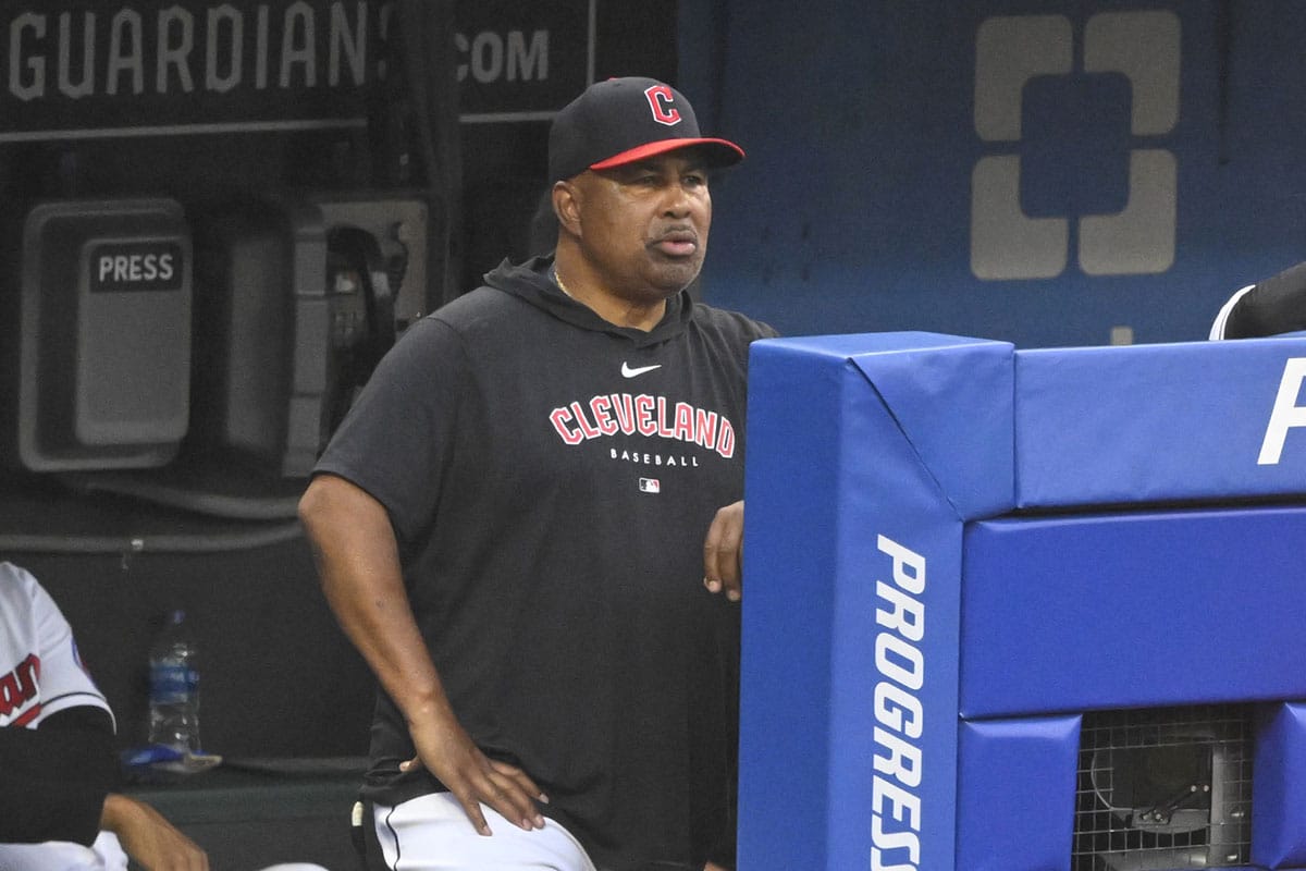 DeMarlo Hale (30), coach of the Cleveland Guardians, stands in the dugout in the fifth inning against the Kansas City Royals at Progressive Field.