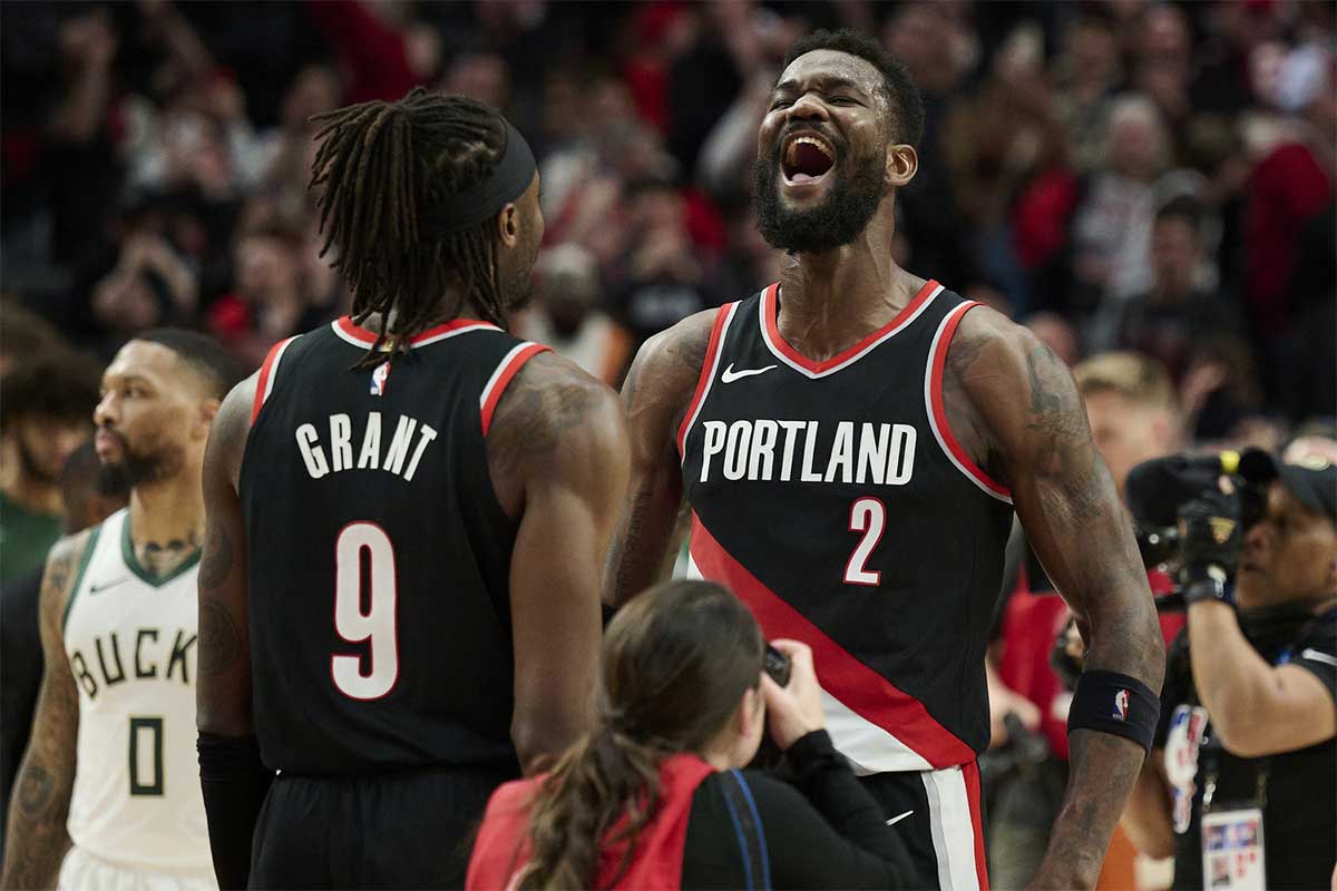 Portland Trail Blazers center Deandre Ayton (2) celebrates with forward Jerami Grant (9) after beating the Milwaukee Bucks at Moda Center.