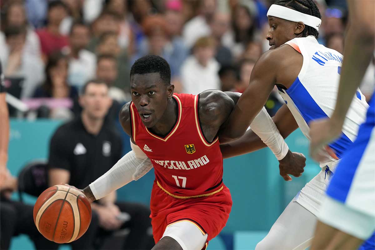 Germany point guard Dennis Schroder (17) controls the ball against France point guard Frank Ntilikina (1) in the first half in a men’s group B basketball game during the Paris 2024 Olympic Summer Games at Stade Pierre-Mauroy. 