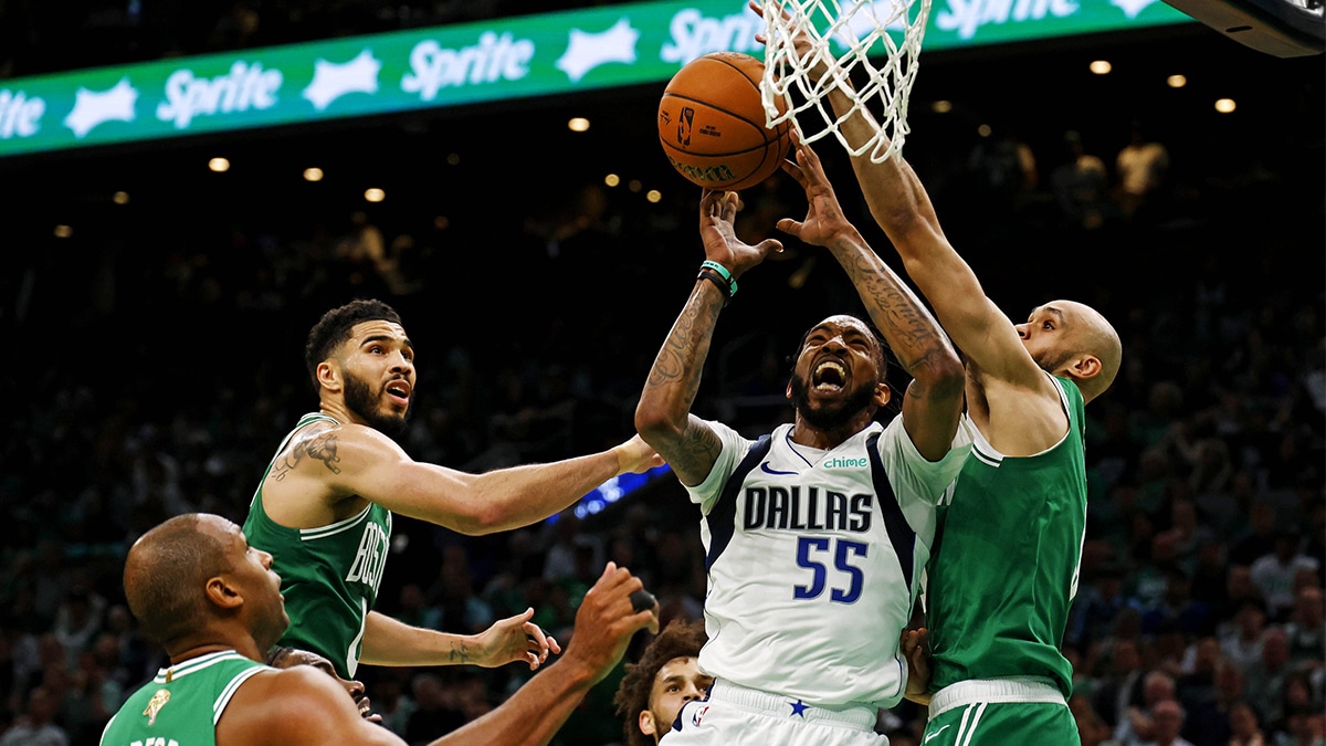 Dallas Mavericks forward Derrick Jones Jr. (55) grabs a rebound against Boston Celtics guard Derrick White (9) and forward Jayson Tatum (0) in game five of the 2024 NBA Finals at TD Garden.