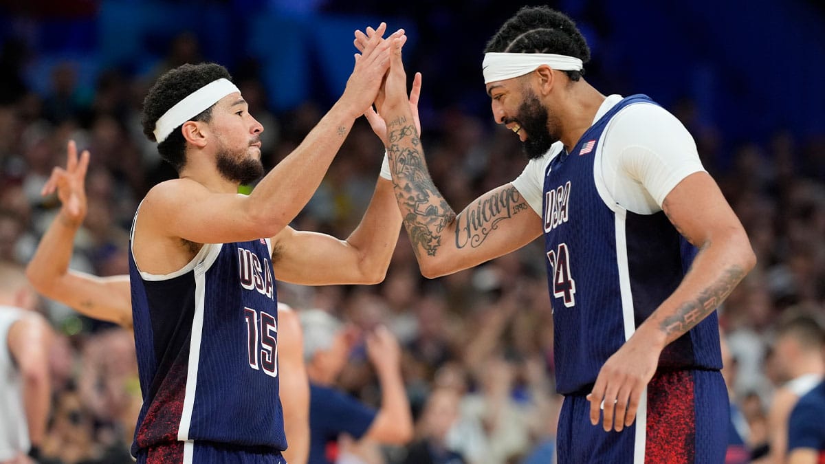 Devin Booker (15) and center Anthony Davis (14) celebrate