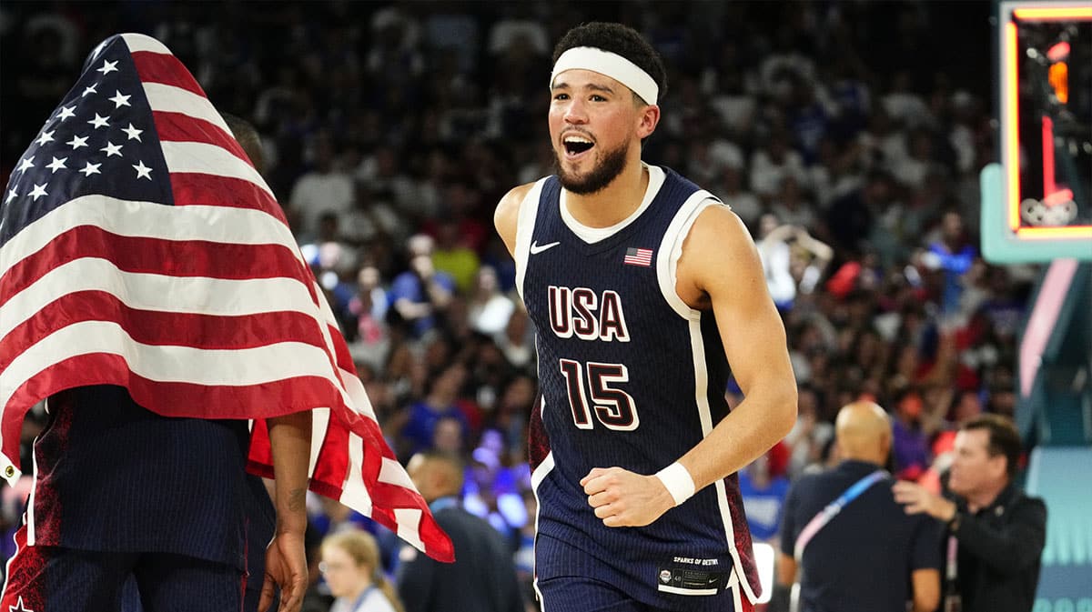 US guard Devin Booker (15) celebrates after defeating France in the men's basketball gold medal game during the 2024 Summer Olympics in Paris at Accor Arena.