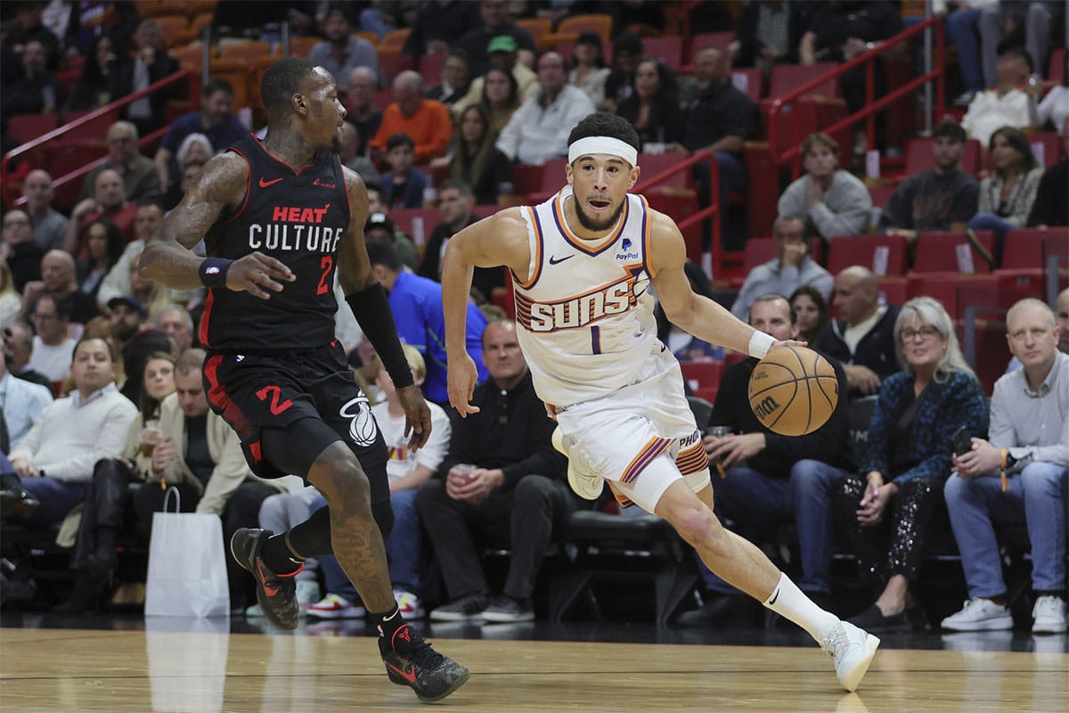 Phoenix Suns guard Devin Booker (1) moves to the basket against Miami Heat guard Terry Rozier (2) during the first quarter at Kaseya Center. 