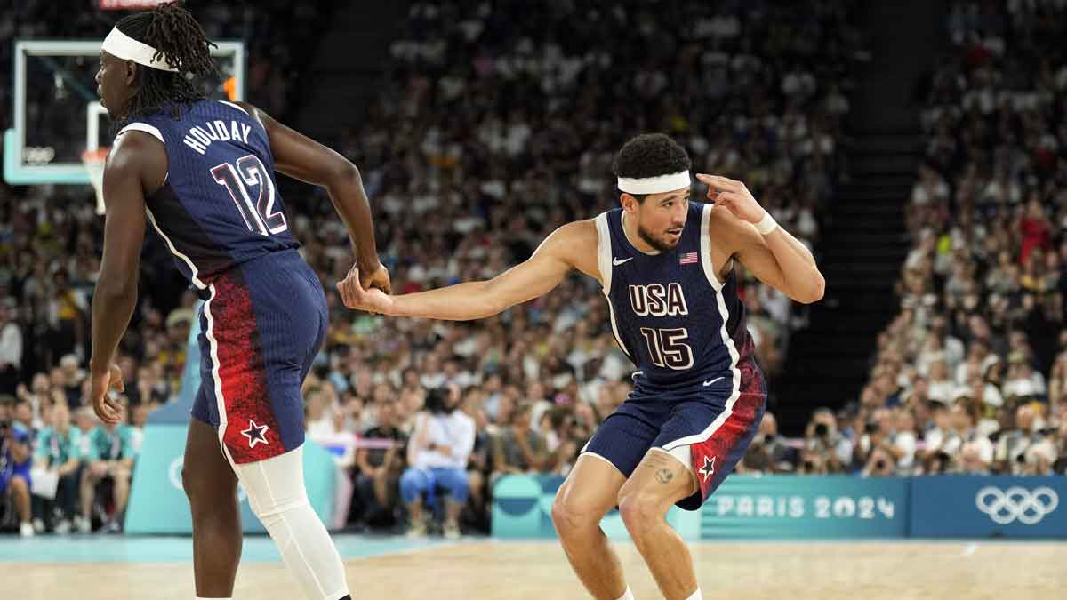 United States guard Devin Booker (15) reacts with guard Jrue Holiday (12) in the first quarter against Brazil in a men’s basketball quarterfinal game during the Paris 2024 Olympic Summer Games at Accor Arena.