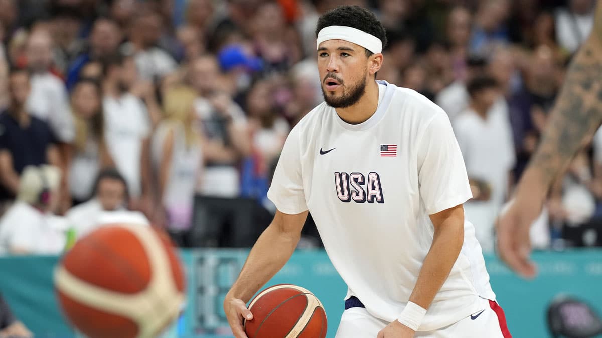 Devin Booker (15) warms up before a game against Serbia