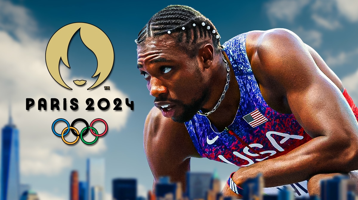 Noah Lyles in Team USA uniform standing next to 2024 Olympics logo