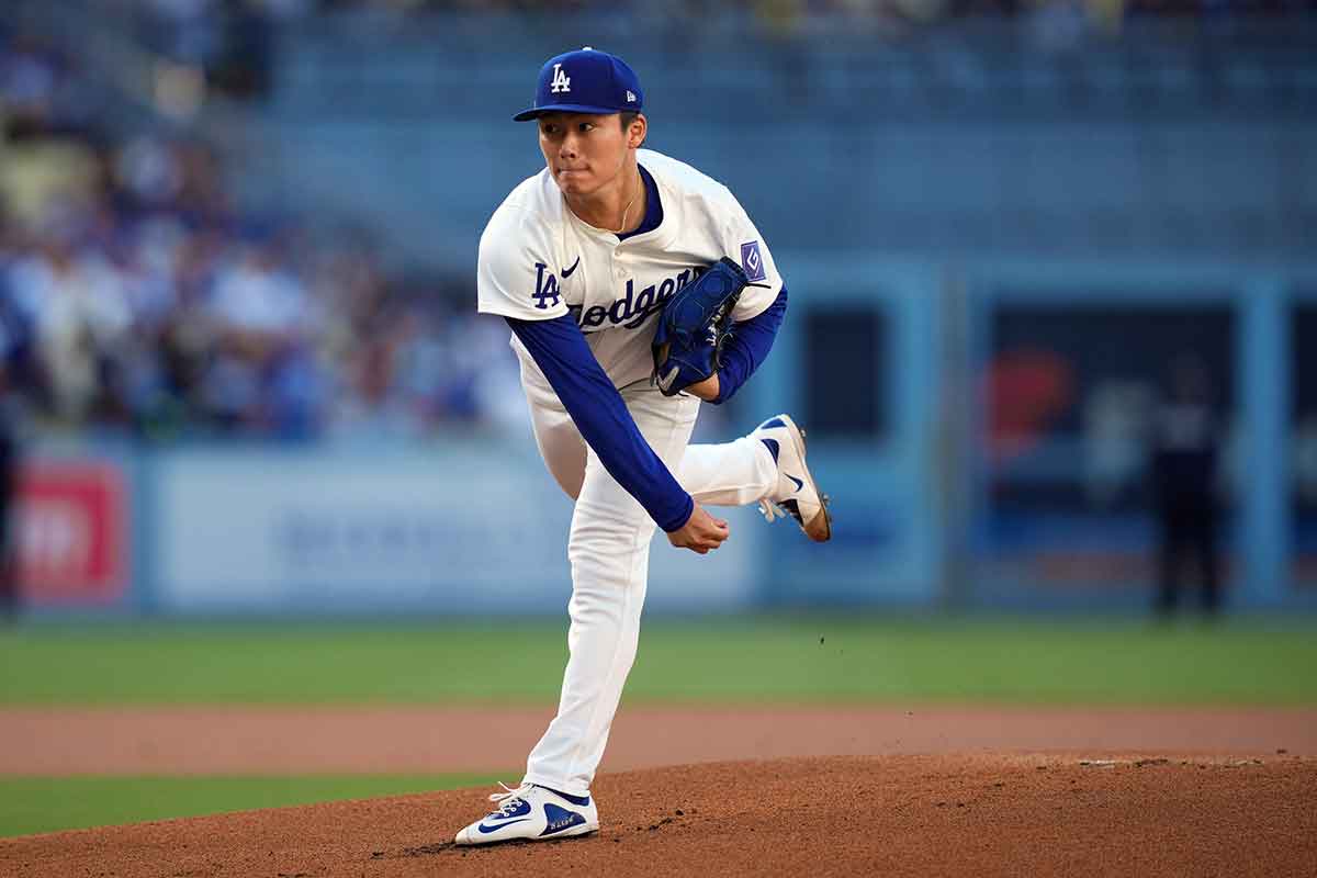 Los Angeles Dodgers starting pitcher Yoshinobu Yamamoto (18) throws in the first inning against the Kansas City Royals at Dodger Stadium. 