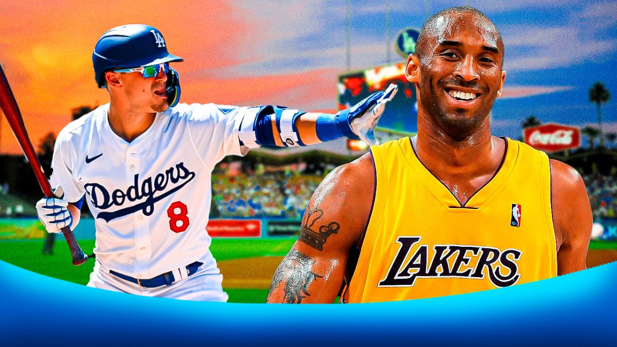 Dodgers' Enrique Hernandez smiling while pointing at a smiling Kobe Bryant