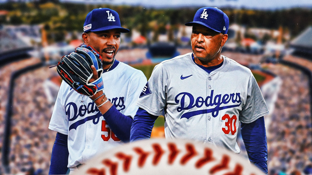 Dodgers' Mookie Betts standing next to manager Dave Roberts with the outfield of Dodgers Stadium in the background