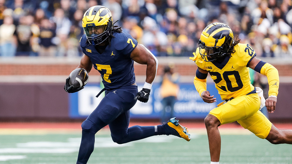 Blue Team running back Donovan Edwards (7) runs against Maize Team defensive back Jyaire Hill (20) during the first half of the spring game at Michigan Stadium