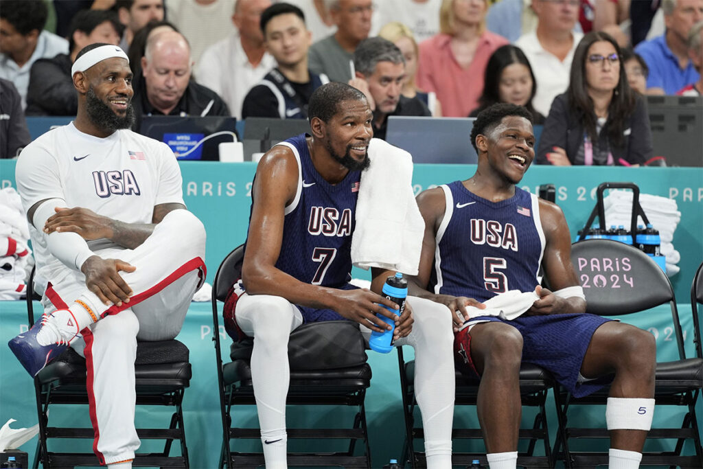 United States guard LeBron James (6), guard Kevin Durant (7) and guard Anthony Edwards (5) on the bench in the fourth quarter against Puerto Rico during the Paris 2024 Olympic Summer Games at Stade Pierre-Mauroy.