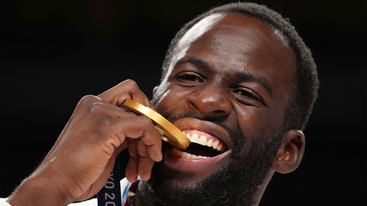 Draymond Green bites his gold medial during the Tokyo 2020 Olympic Summer Games at Saitama Super Arena.