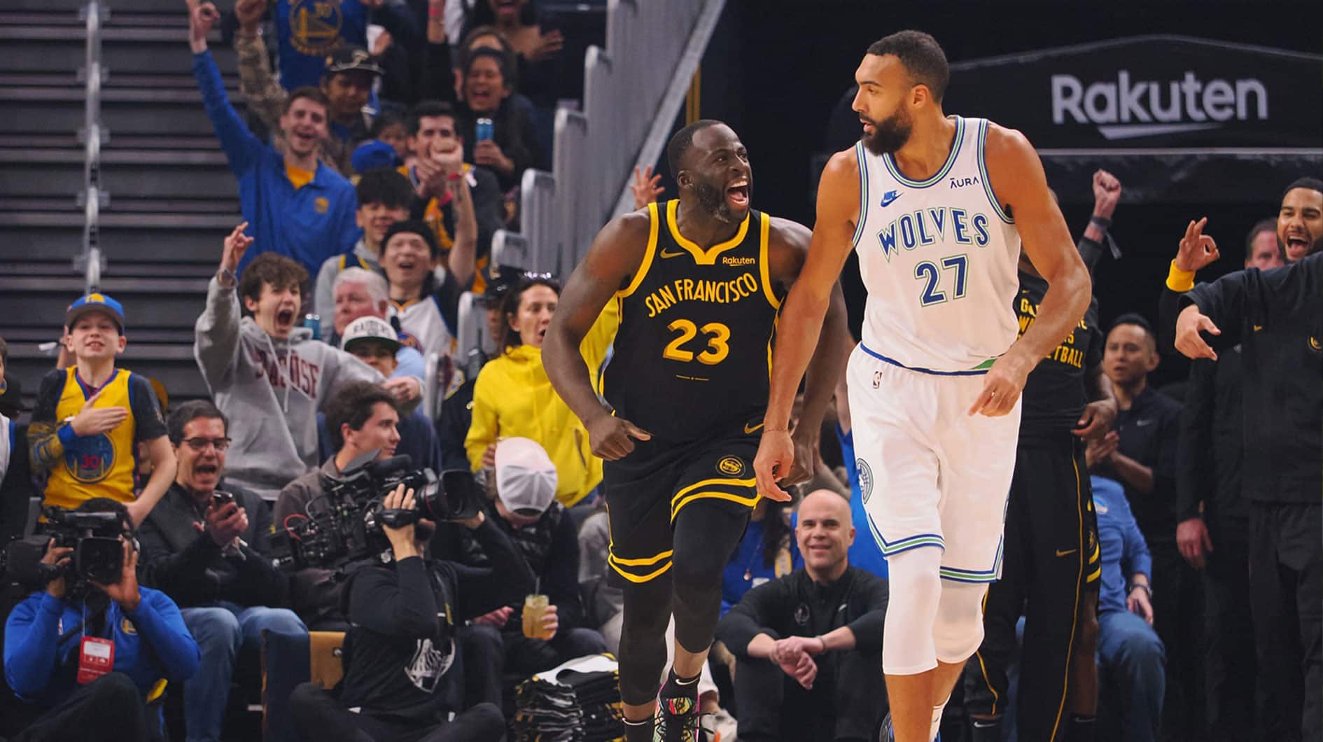 Golden State Warriors forward Draymond Green (23) celebrates behind Minnesota Timberwolves center Rudy Gobert (27) after scoring a three point basket during the first quarter at Chase Center. 