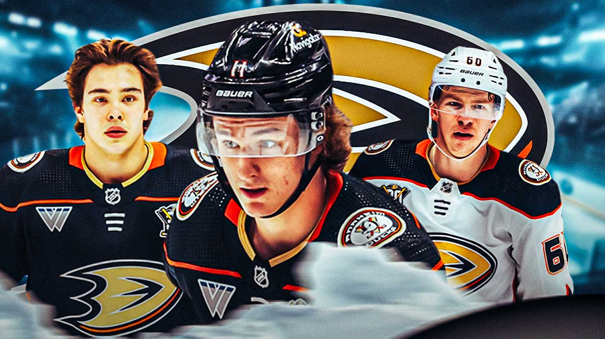 Trevor Zegras in middle looking stern, Jackson Lacombe and Olen Zellweger on either side, Anaheim Ducks logo, hockey rink in background