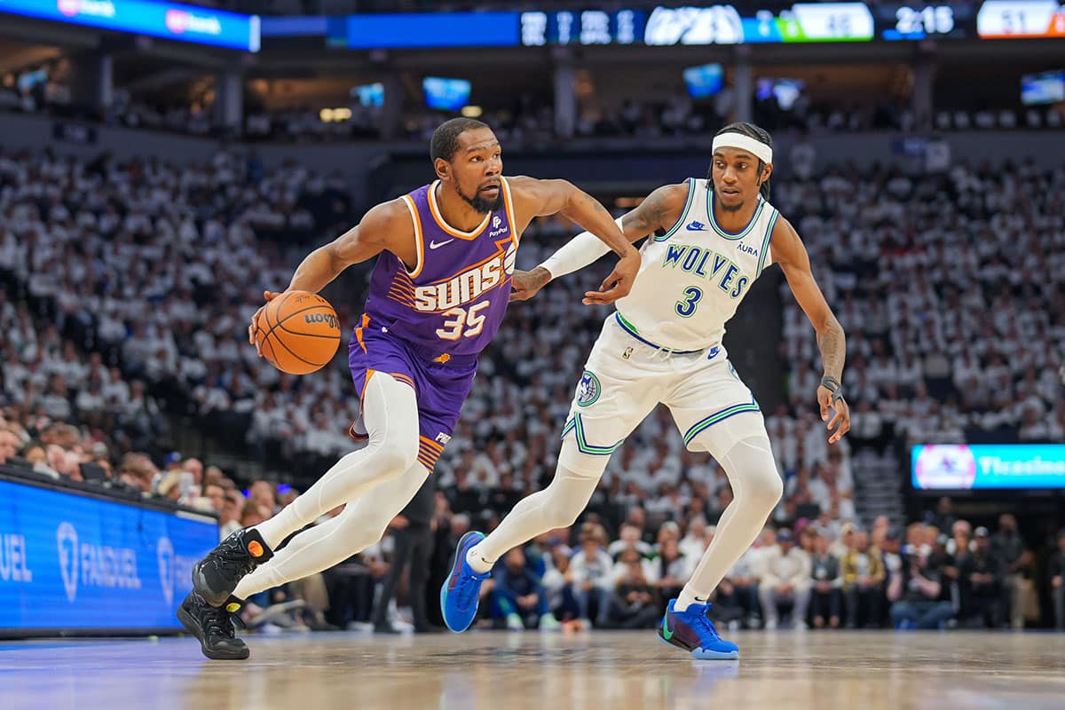 Phoenix Suns forward Kevin Durant (35) dribbles against Minnesota Timberwolves forward Jaden McDaniels (3) in the second quarter during game two of the first round for the 2024 NBA playoffs at Target Center.