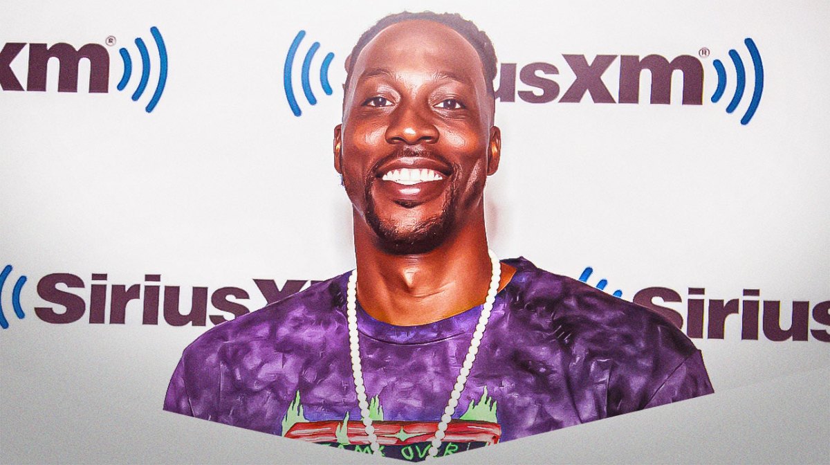 Dwight Howard smiling wearing street clothes.