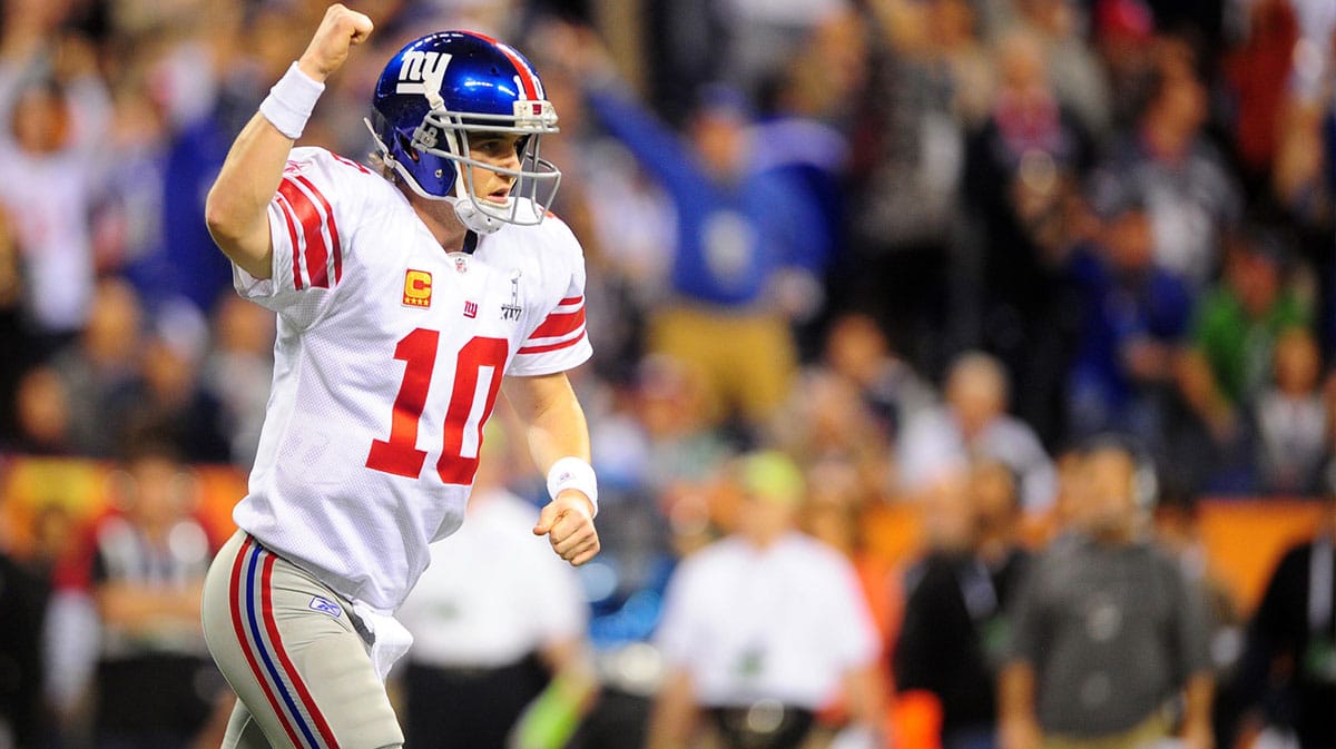 New York Giants quarterback Eli Manning (10) reacts after throwing a touchdown pass during the first half of Super Bowl XLVI against the New England Patriots at Lucas Oil Stadium.