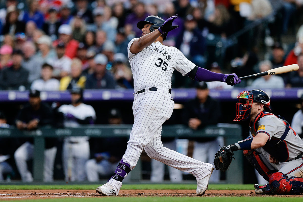 Colorado Rockies catcher Elias Diaz (35) hits an RBI double in the fourth inning against the Atlanta Braves at Coors Field.