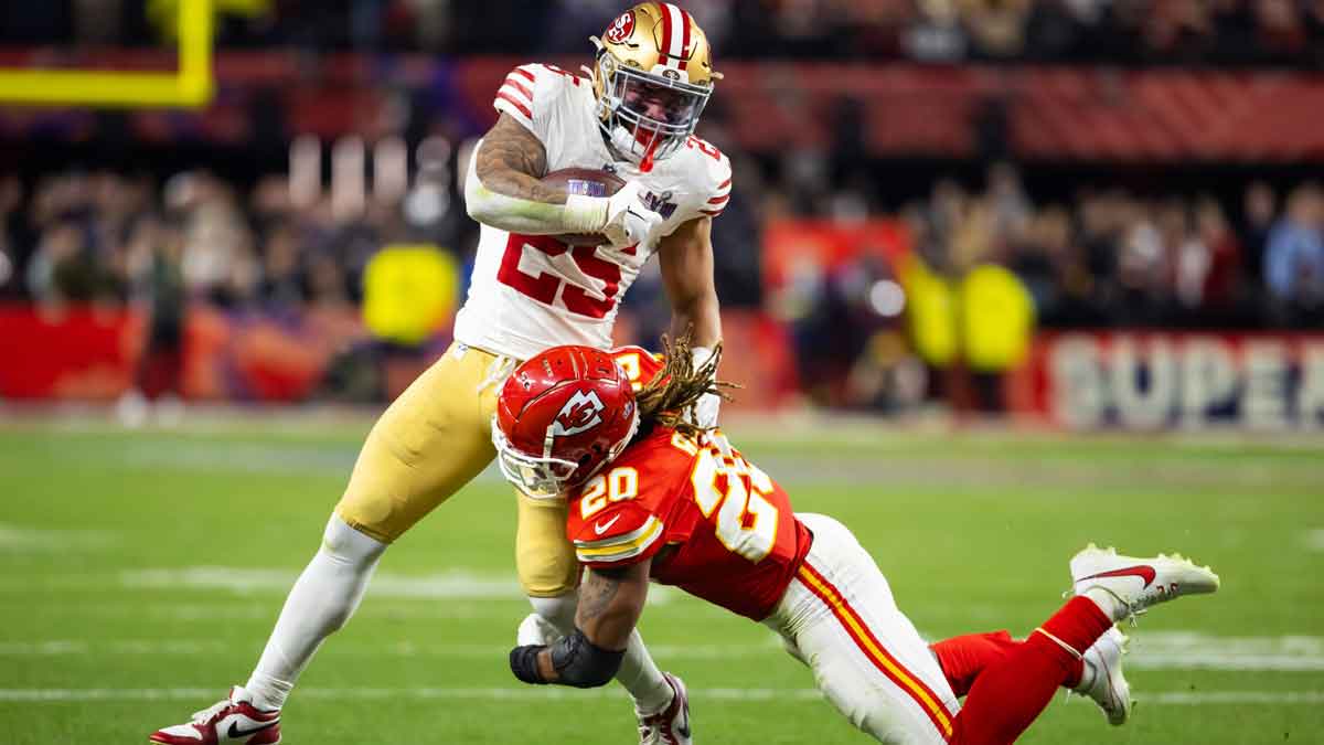 San Francisco 49ers running back Elijah Mitchell (25) is tackled by Kansas City Chiefs safety Justin Reid (20) in Super Bowl LVIII at Allegiant Stadium.