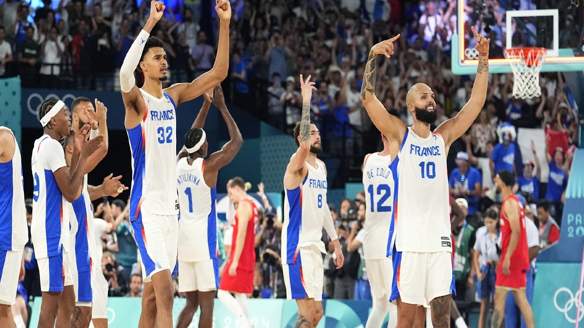 France power forward Victor Wembanyama (32) and shooting guard Evan Fournier (10) celebrate after the game against Germany in a men's basketball semifinal game during the Paris 2024 Olympic Summer Games at Accor Arena. 