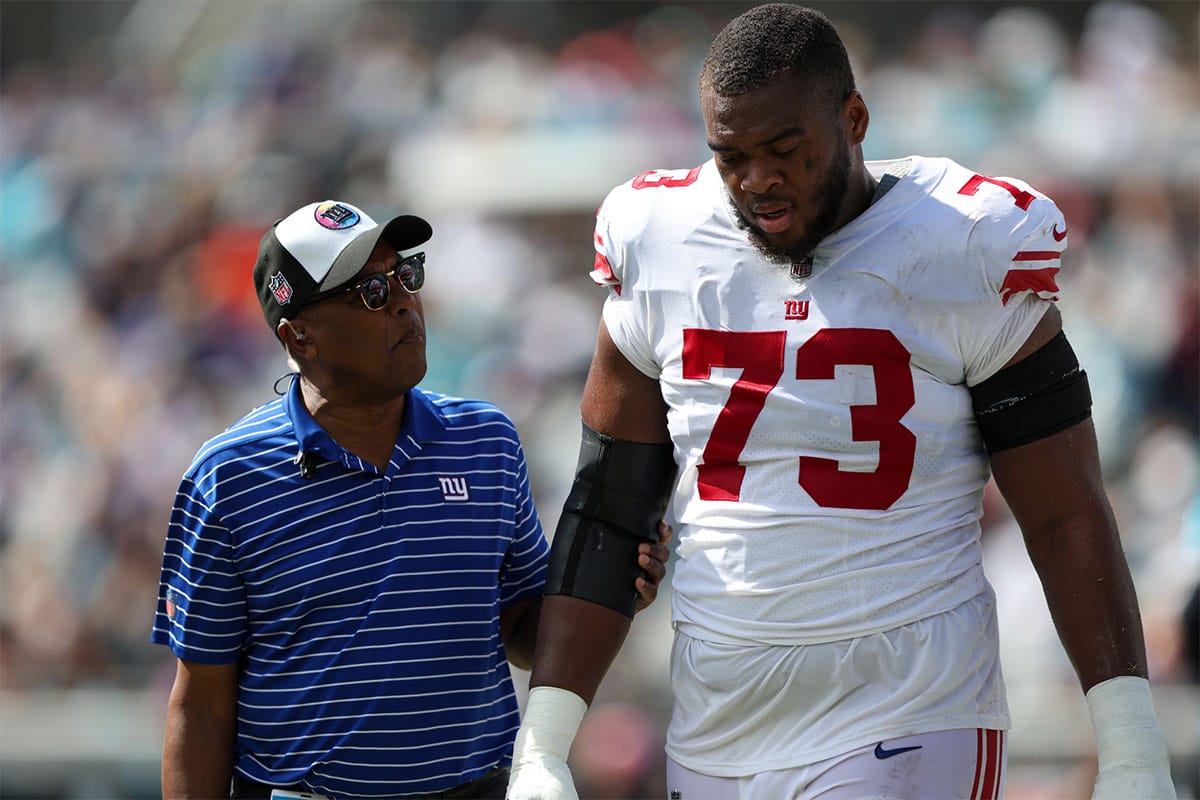 New York Giants offensive tackle Evan Neal (73) leaves the field with an injury against the Jacksonville Jaguars in the second quarter at TIAA Bank Field.